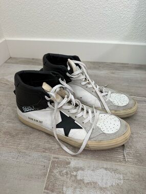 Golden Goose Deluxe Brand Mid Star model in a white and black colorway.
